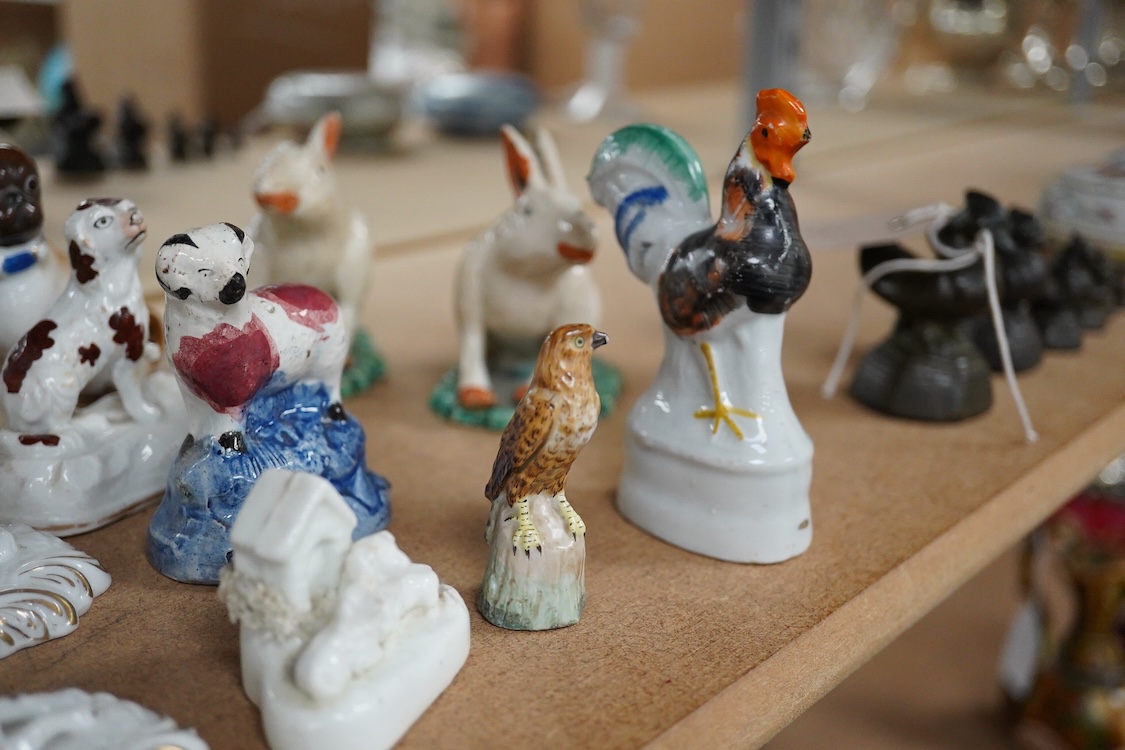 A collection of 19th/20th century Staffordshire and continental porcelain models of animals and birds, including a 20th century Meissen figure of a canary, two Continental porcelain Panthers, two similar recumbent dogs,